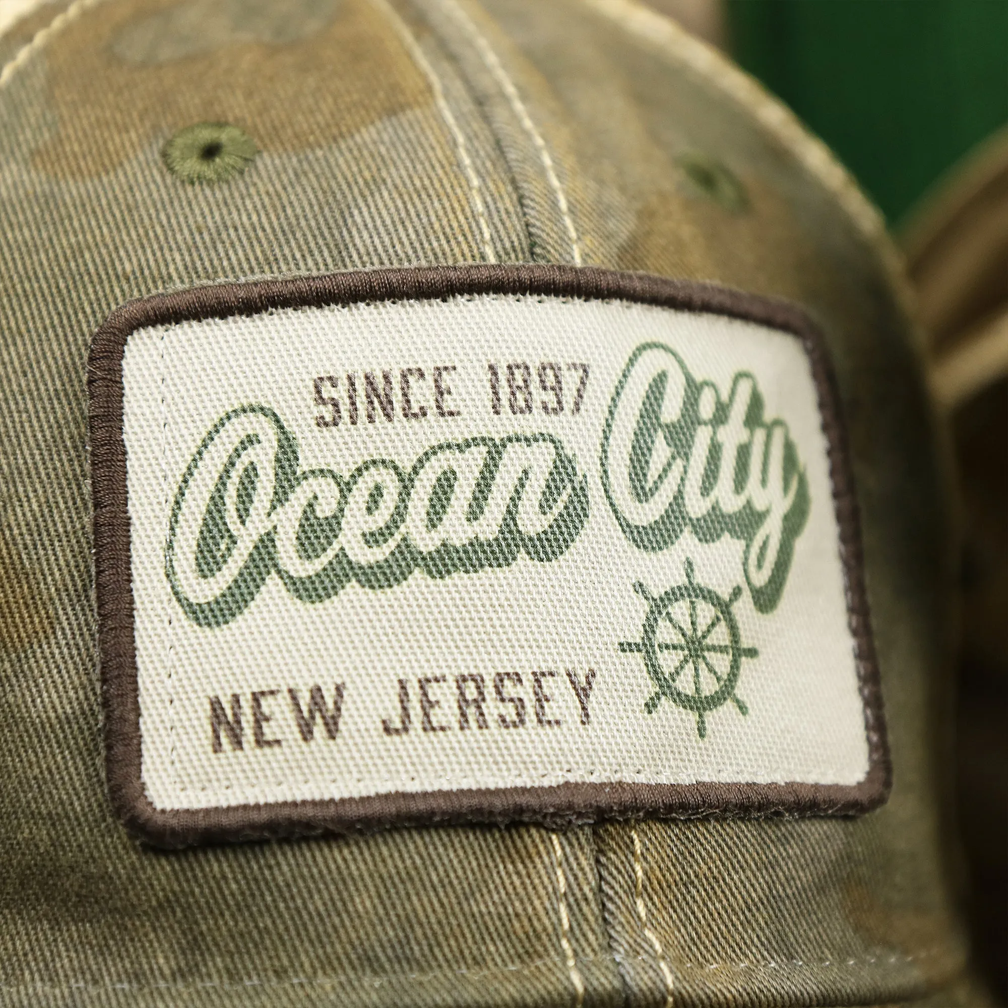 Ocean City New Jersey Since 1897 Helm Patch Camo Print Mesh Back Trucker Hat | Camo Green Trucker Hat